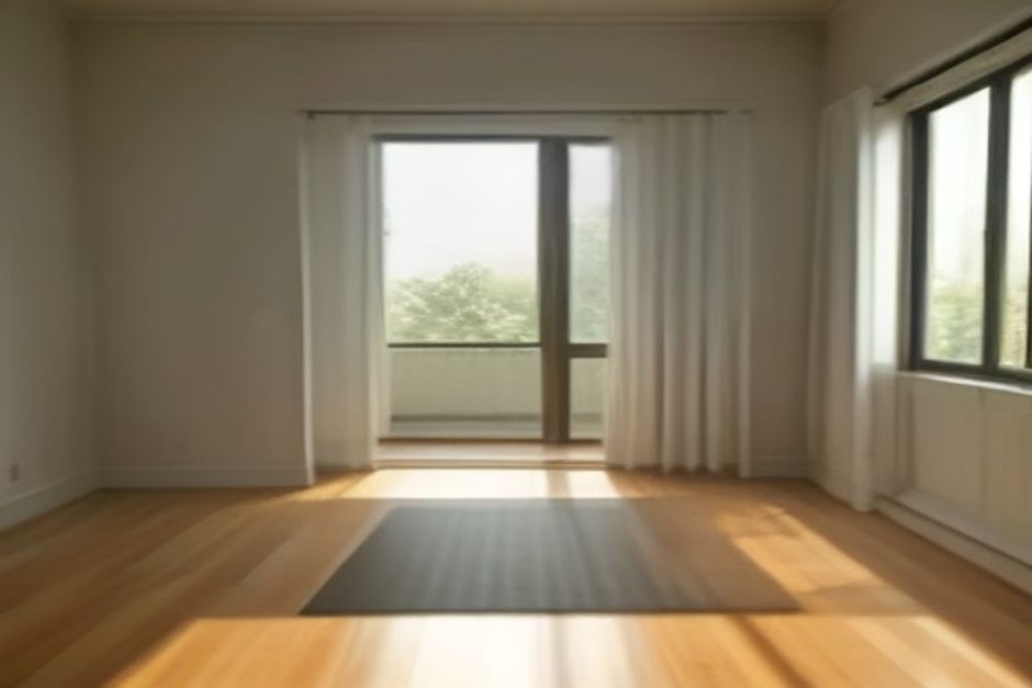 A calm home yoga space beside a large mirror, a mat and block on a wooden floor in daylight