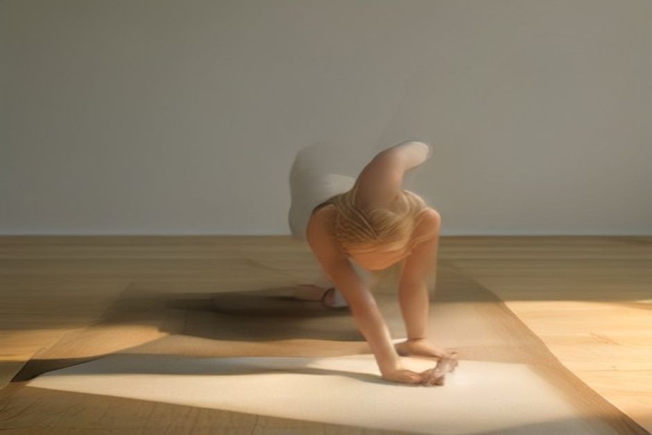 Person holding Chaturanga low push-up position with elbows bent above a yoga mat