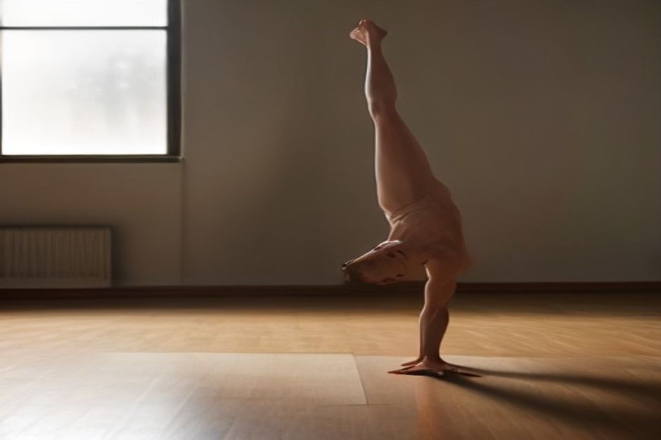 Man balancing in Warrior III pose with torso parallel to the floor